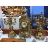 A modern ornate gilt metal clock garniture