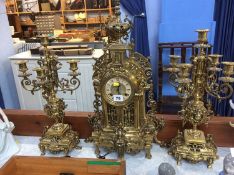 A modern ornate gilt metal clock garniture
