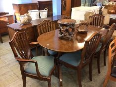 A reproduction mahogany dining room suite