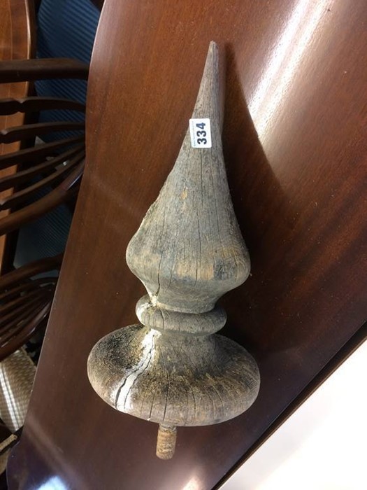 A large wooden finial