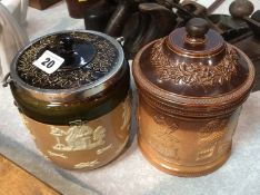 A Doulton stoneware jar and cover and a Doulton Lambeth stoneware biscuit barrel with silver mounts