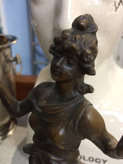 An early 20th century Spelter clock, the clock movement balanced on the Ladies hand - Image 3 of 3