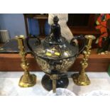 A Victorian urn and a pair of brass candlesticks