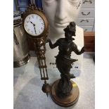 An early 20th century Spelter clock, the clock movement balanced on the Ladies hand