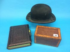 A small Victorian photograph album, a bowler hat and a tea caddy