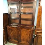A Victorian mahogany glazed bookcase, with two plain panelled doors below, 124cm wide