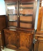 A Victorian mahogany glazed bookcase, with two plain panelled doors below, 124cm wide