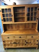 An oak 'Knightman' dresser with raised and glazed back, below three short drawers and three cupboard