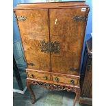 A walnut cocktail cabinet, 68cm wide x 158cm high