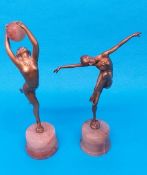 Two Art Deco spelter figures, one holding aloft an alabaster ball, the other with arms