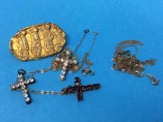 Three costume jewellery crucifixes together with a yellow metal brooch