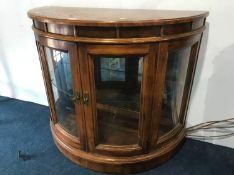 A mahogany demi lune two door glazed cabinet, 92cm wide