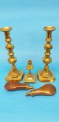 A large pair of brass candlesticks, two copper and brass powder flasks etc.