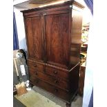 A 19th century mahogany linen press with plain panelled doors, below two short and two long drawers,