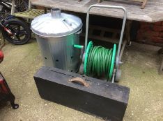Garden incinerator together with a roll up hose pipe