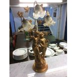 A decorative cherub three branch table lamp