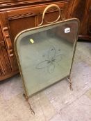 A Victorian glass and brass fire screen