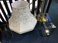 A chrome and glass top table and a standard lamp