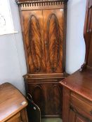 A reproduction mahogany corner cabinet