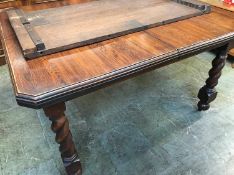An oak barley twist extending dining table, with two leaves