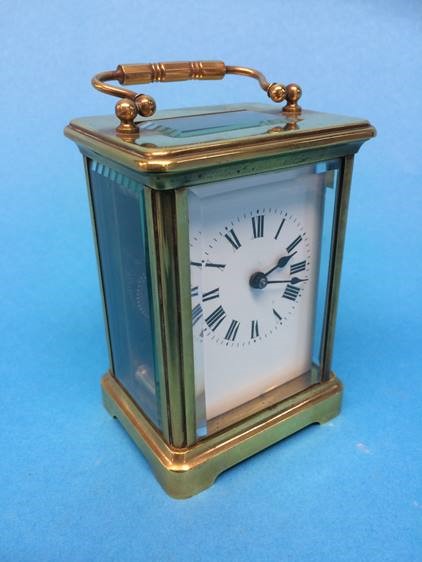 A brass carriage clock, with unsigned dial, the movement stamped 'Made in France'