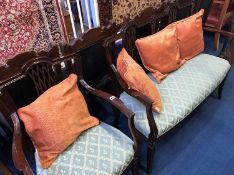 A reproduction mahogany two seater settee and carver chair