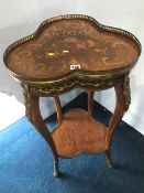 A Louis XV style trefoil top two tier occasional table with hoof feet, 47cm wide