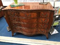 A reproduction mahogany Chapmans 'Siesta' serpentine chest of drawers, with tooled leather