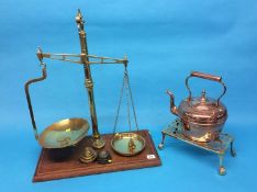 A set of brass weights and scales, G. and W. Pairman, Newcastle, a brass trivet and copper kettle