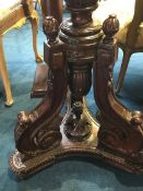 A reproduction mahogany torchere pedestal