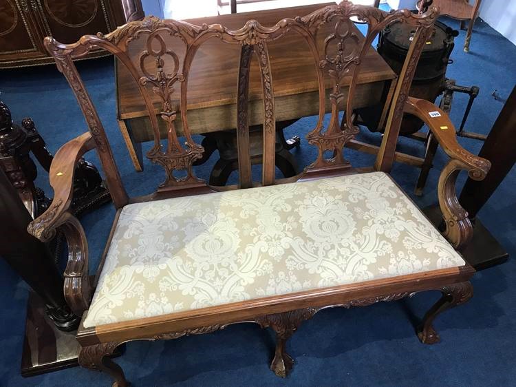 A reproduction mahogany two seater window seat