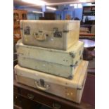 Three Velum covered suitcases