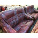 Two burgundy settees and oak coffee table