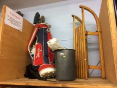 Sledge and a set of golf clubs