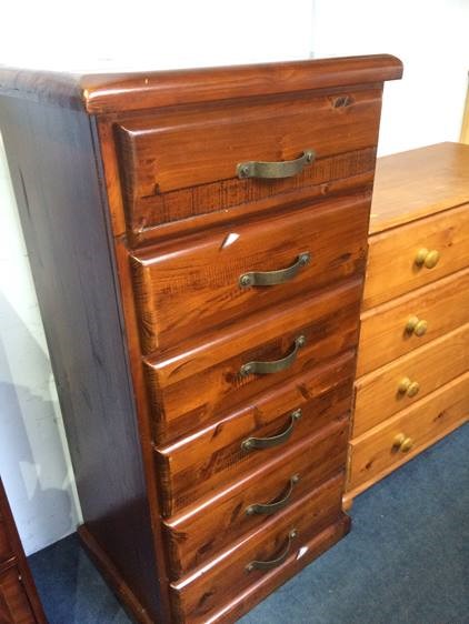 A narrow pine six drawer chest