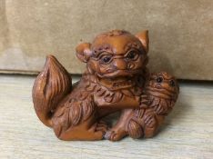 A carved boxwood netsuke