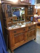An oak Arts and Crafts bow front sideboard