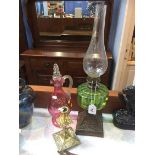 Oil lamp, decanter and a candlestick