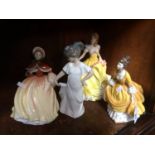 Three Royal Doulton figures and a Nao figure