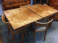 A Mckintosh of Scotland teak extending table and chairs (two fold out leaves)