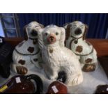Pair of Staffordshire dogs and one single dog