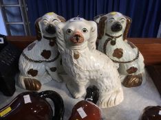 Pair of Staffordshire dogs and one single dog