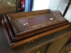 Three carved hardwood trays