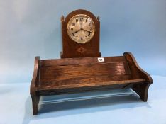 A mahogany mantle clock and a book slide