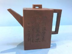 A Japanese tea pot, decorated with incised characters
