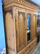 A large pine Gothic design triple door wardrobe