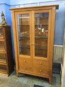 A Chapmans 'Siesta' oak two door glazed cabinet