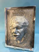 Relief portrait of Han Solo frozen in carbonite