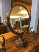 A circular dressing table mirror