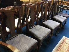 A set of four walnut Queen Anne style single chairs